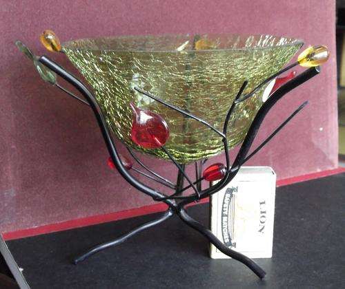 Glass display bowl on metal stand, edge chips