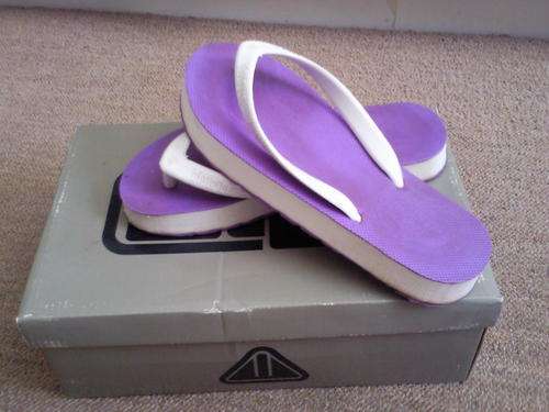 Purple and white branded biotribe flip flops
