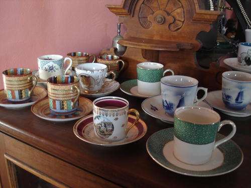 COLLECTION OF COFFEE CANS AND SAUCERS