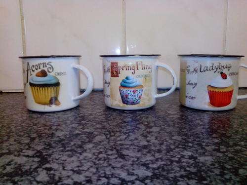 Homemade rustic designs on white enamel mugs. This looks fantastic in a kitchen.