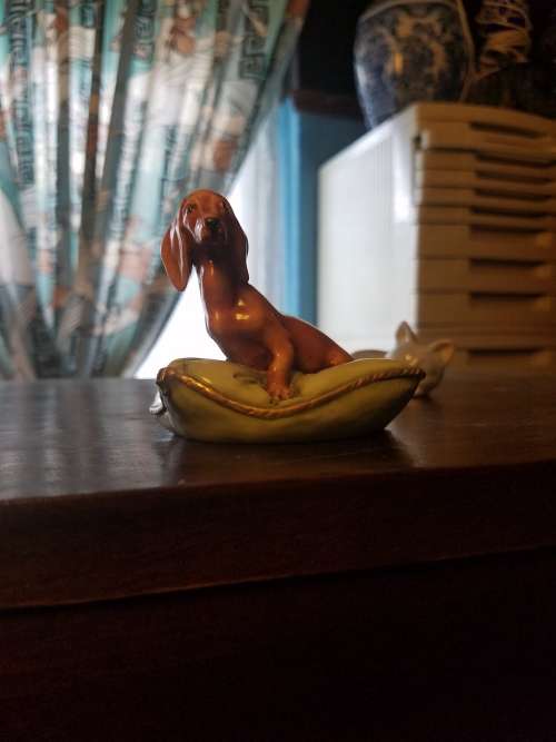 Porcelain dog on pillow