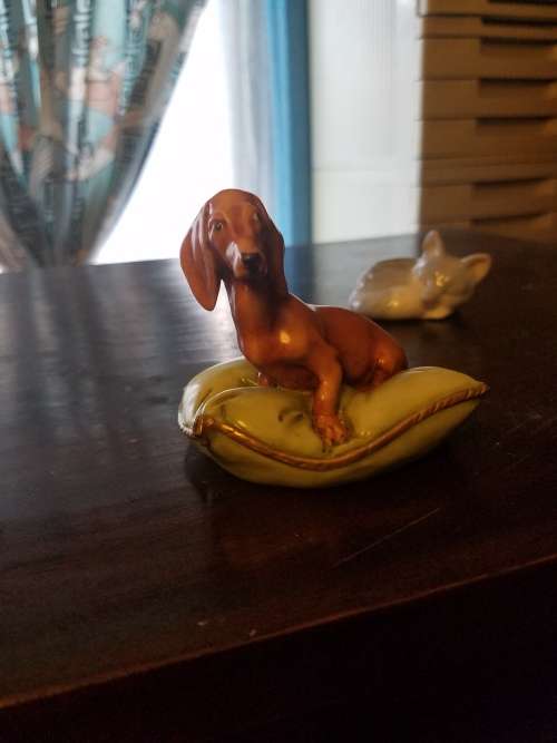 Porcelain dog on pillow