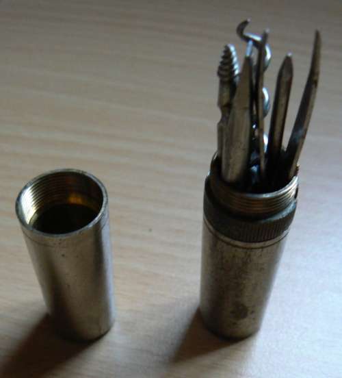 Vintage compact multitool with four bits plus tweezer