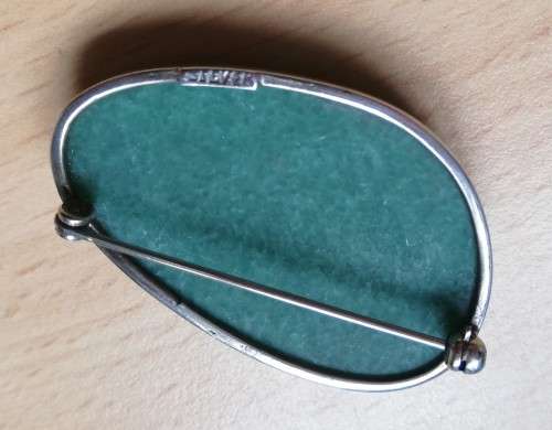 Vintage silver brooch with green semi-precious stone