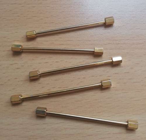 Collection of five gold-coloured tie pins
