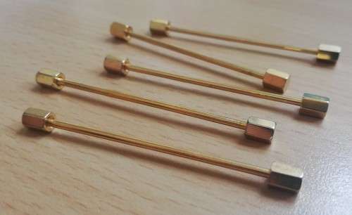 Collection of five gold-coloured tie pins