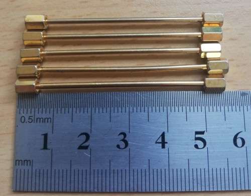 Collection of five gold-coloured tie pins