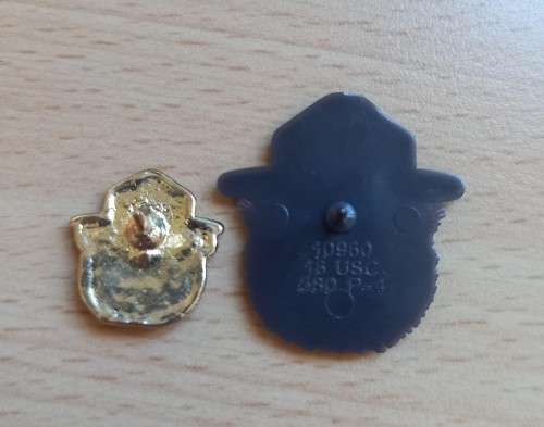 Pair of vintage Smokey Bear US lapel pin badges