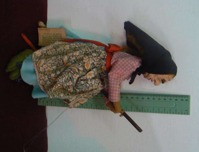 Handmade witch doll on broomstick