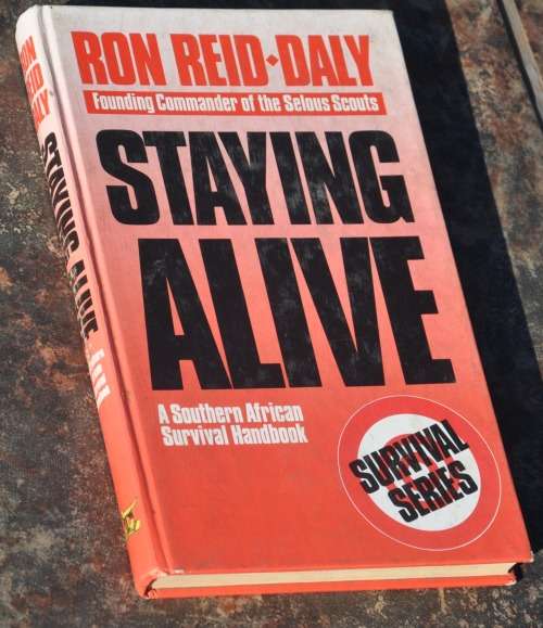 STAYING ALIVE: A SOUTHERN AFRICAN SURVIVAL HANDBOOK - demanding Africana/Militaria collectible
