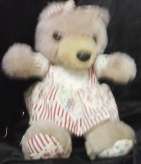 A Purple bear with a white dress with flowers on it- (+- 21 cm High)