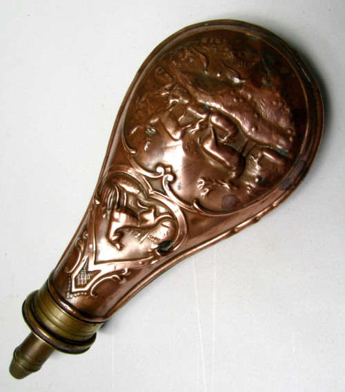 antique brass and copper powder flask for display.