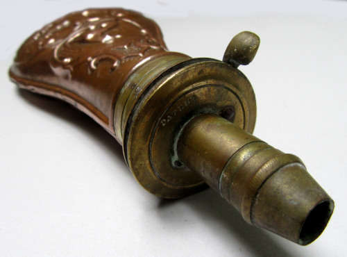 antique brass and copper powder flask for display.