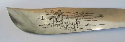 decorative dagger in cow hide sheath, metal blade with makers mark and cow hand engraving VGC