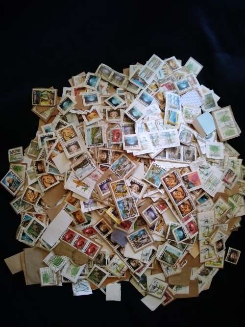 Zimbabwe. A mountain of used stamps on paper Unchecked. Duplications.