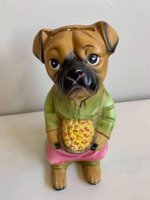 Large ceramic dog figurine that is also a piggy bank