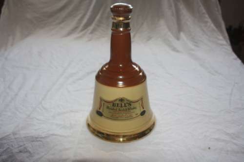 BELLS BLENDED SCOTCH WHISKEY IN WADE BELL SHAPED BOTTLE