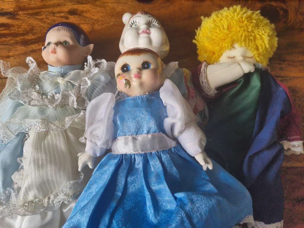 One bid for the Family  four vintage porcelain dolls