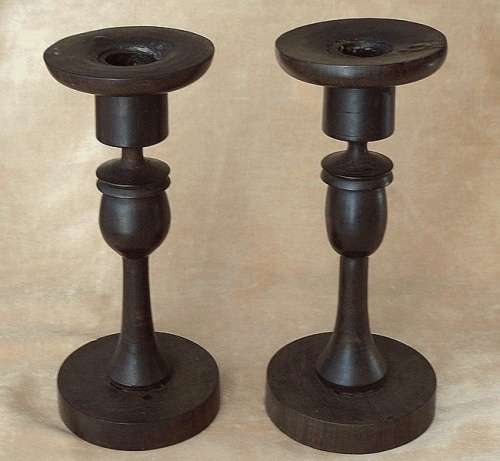 A PAIR OF HAND CARVED WOODEN CANDLE HOLDERS