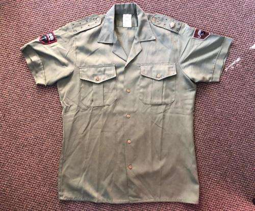 RHODESIAN OLIVE GREEN SHIRT WITH PATCHES AND MAKERS LABEL-SIZE LARGE-MEASURES 55 CM ARMPIT TO ARMPIT