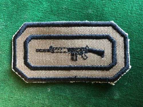 SADF PERIOD MARKSMAN BADGE NUTRIA BACKING WITH BLACK EMBROIDERED BORDER