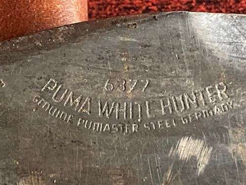 PUMA WHITE HUNTER KNIFE-STAGHORN SHARPENED SECTION ON TOP EDGE AND 1 INCH SERRATED SECTION ON BOTTOM