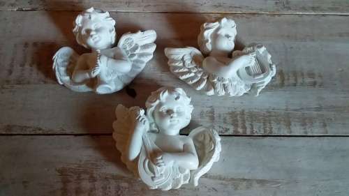 Three Cherubs Playing Musical Instruments