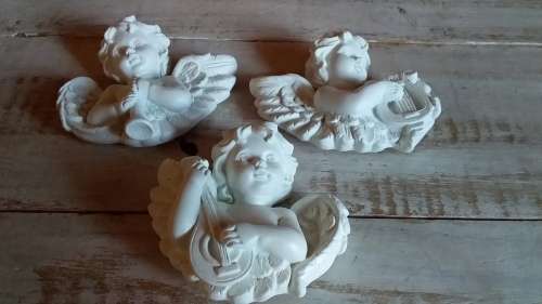 Three Cherubs Playing Musical Instruments