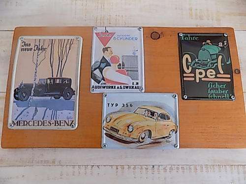 Four Metal Plaques Depicting Vintage Cars on Pine Board