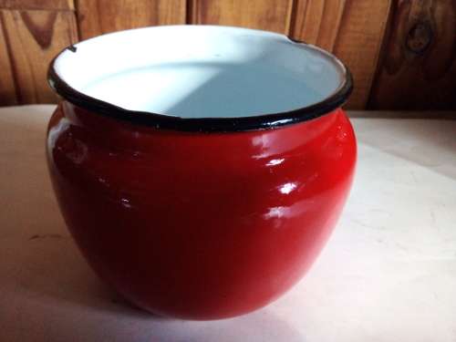 Red Enamelware Container with Black Trim and White Interior