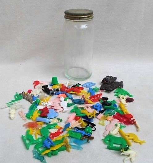 A SMALL VINTAGE 1953 TALANA BOTTLE FILLED WITH VINTAGE PLASTIC CHARMS - MORE THAN 130 OF THEM!!