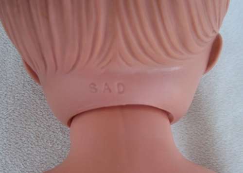 A LOVELY VINTAGE DOLL WITH A SWEET INNOCENT FACE - MARKED 'SAD' ON BACK OF HEAD