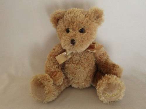 A PRETTY HARRODS BEAR WITH TINSEL IN HIS FUR