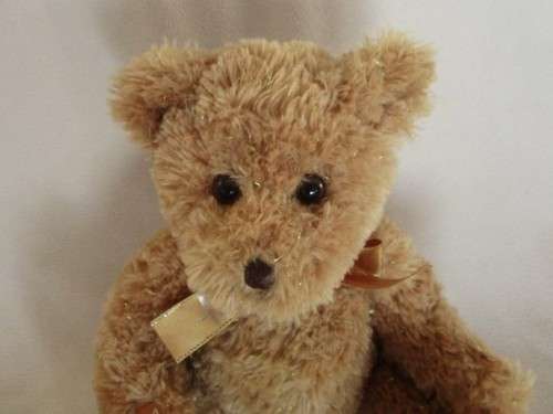 A PRETTY HARRODS BEAR WITH TINSEL IN HIS FUR