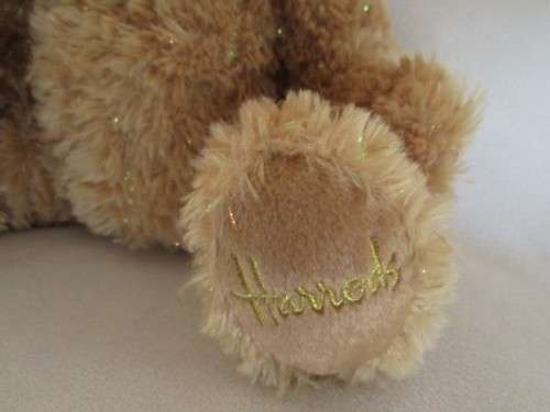 A PRETTY HARRODS BEAR WITH TINSEL IN HIS FUR
