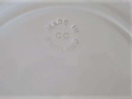 A PRETTY BLUE AND WHITE WILLOW PATTERN PLATE - IMPRESSED 'MADE IN ENGLAND'