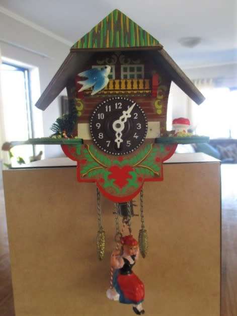 A SMALL VINTAGE NOVELTY CLOCK WITH GERMAN FRAULEIN ON SWING - WORKING???