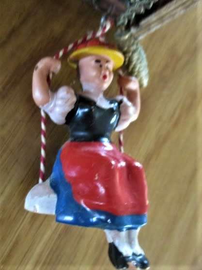 A SMALL VINTAGE NOVELTY CLOCK WITH GERMAN FRAULEIN ON SWING - WORKING???