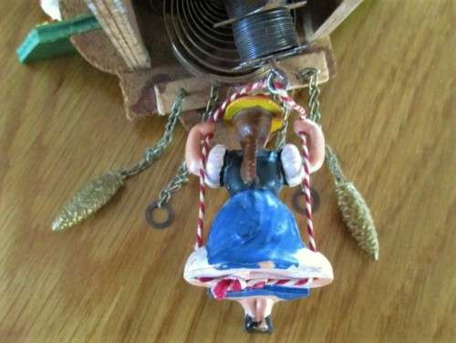 A SMALL VINTAGE NOVELTY CLOCK WITH GERMAN FRAULEIN ON SWING - WORKING???