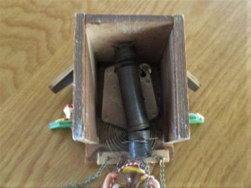 A SMALL VINTAGE NOVELTY CLOCK WITH GERMAN FRAULEIN ON SWING - WORKING???