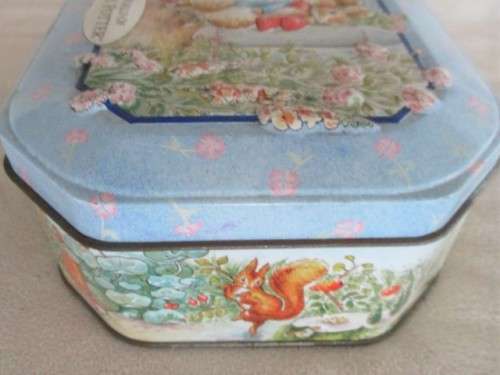 A COLLECTABLE BENTLEY'S OF LONDON TIN WITH RAISED RELIEF DESIGN - THE WORLD OF BEATRIX POTTER
