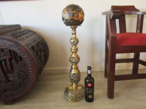 GORGEOUS!! ENORMOUS ORNATE BRASS CANDLE HOLDER WITH CANDLE (COMPARE SIZE TO WINE BOTTLE AND CHAIR)
