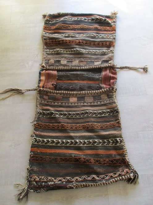 A VINTAGE/ANTIQUE HAND WOVEN MIDDLE EASTERN CAMEL SADDLE BAG IN NEED OF TLC