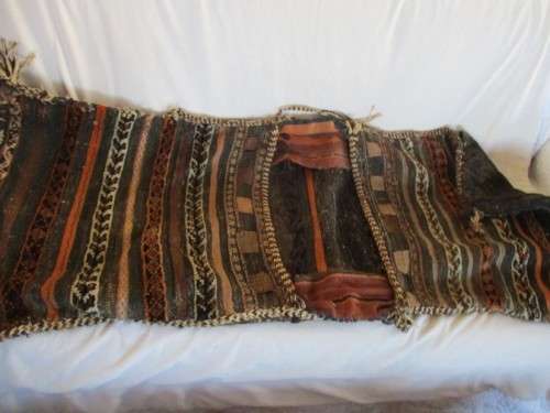 A VINTAGE/ANTIQUE HAND WOVEN MIDDLE EASTERN CAMEL SADDLE BAG IN NEED OF TLC