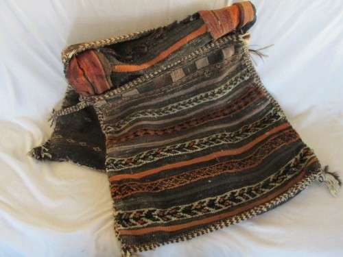 A VINTAGE/ANTIQUE HAND WOVEN MIDDLE EASTERN CAMEL SADDLE BAG IN NEED OF TLC