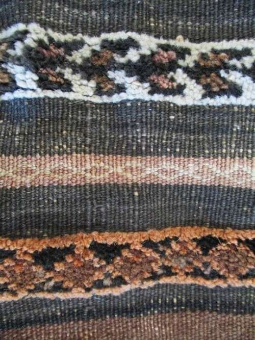 A VINTAGE/ANTIQUE HAND WOVEN MIDDLE EASTERN CAMEL SADDLE BAG IN NEED OF TLC