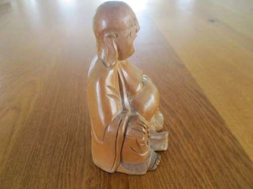 A NICE-SIZED CARVED WOODEN BUDDHA
