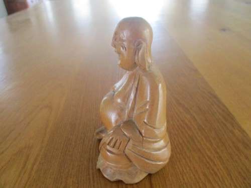 A NICE-SIZED CARVED WOODEN BUDDHA