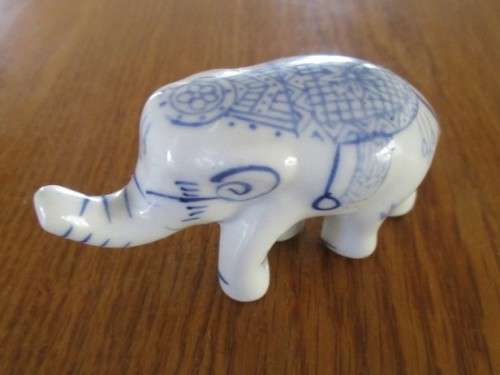 FOUR VERY CUTE AND ORNATE BLUE AND WHITE PORCELAIN ELEPHANTS