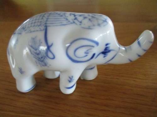FOUR VERY CUTE AND ORNATE BLUE AND WHITE PORCELAIN ELEPHANTS